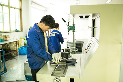 Technician using a specialized C-clamp to safely compress a gas spring